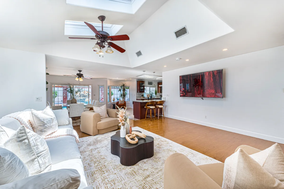 Open-plan living room and kitchen with vaulted ceiling, captured for a Matterport virtual tour